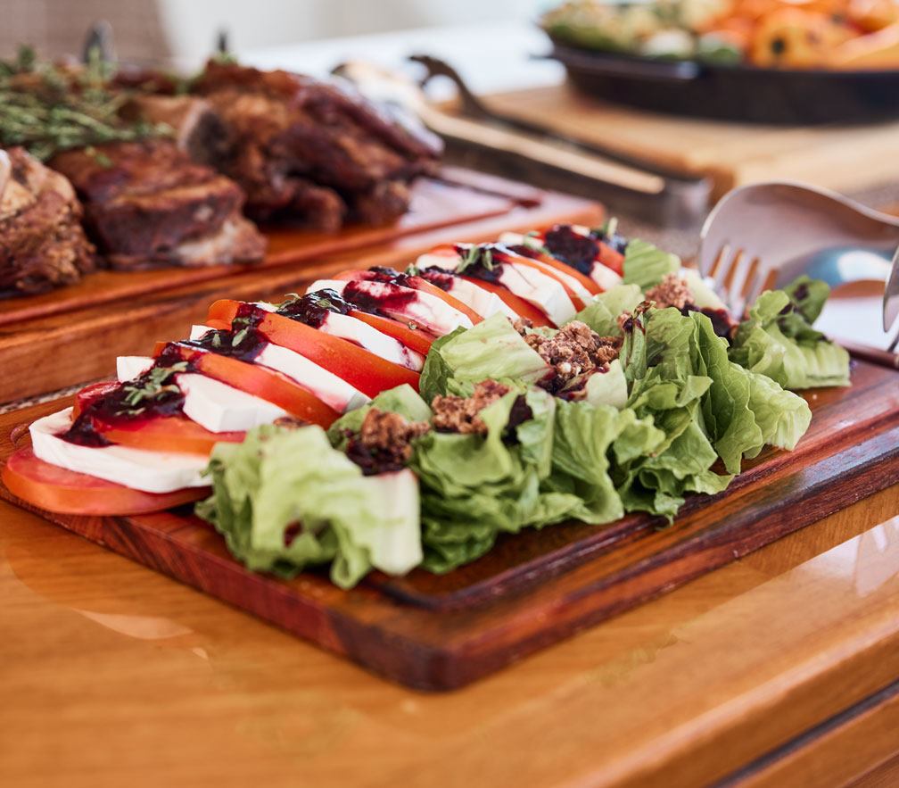 Caprese salad and carved meats prepared by the chef on a Cabo charter
